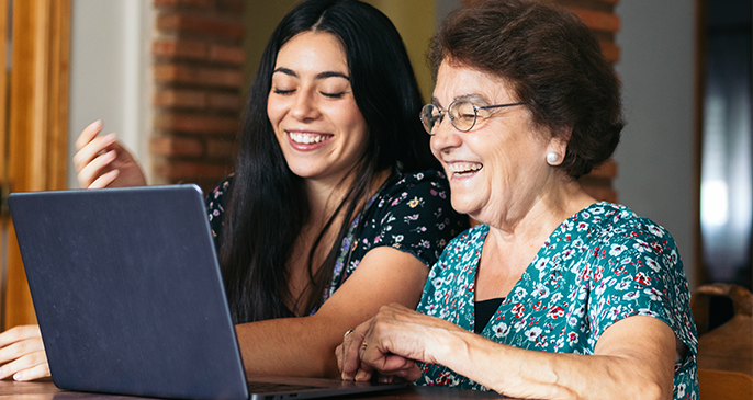 Grandmother and Granddaughter on Laptop