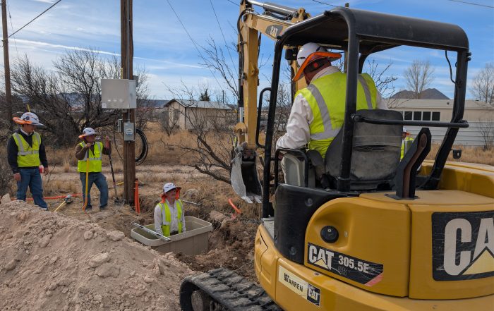Workers expanding fiber